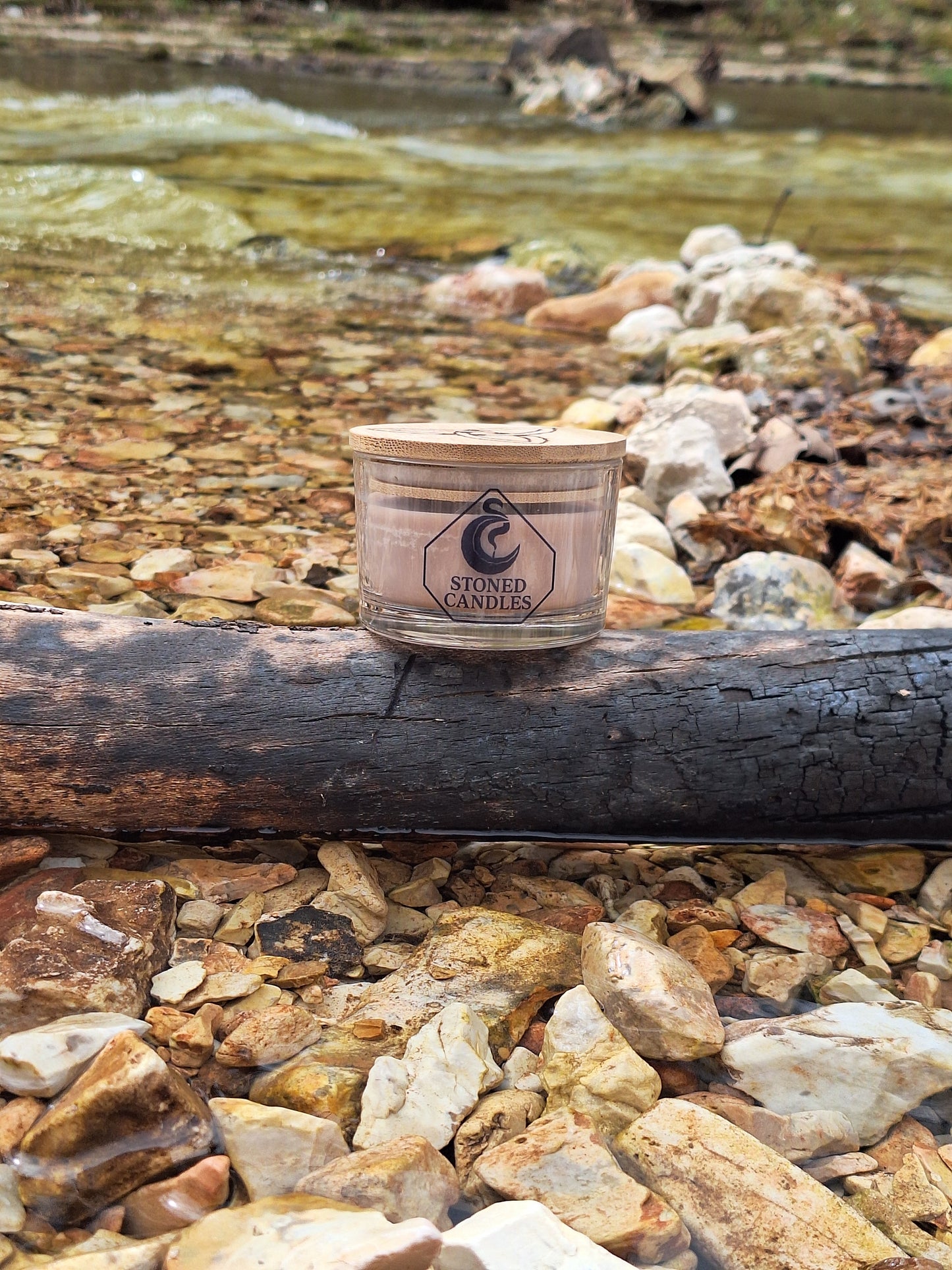 Small cylindrical container with a label on a rocky surface