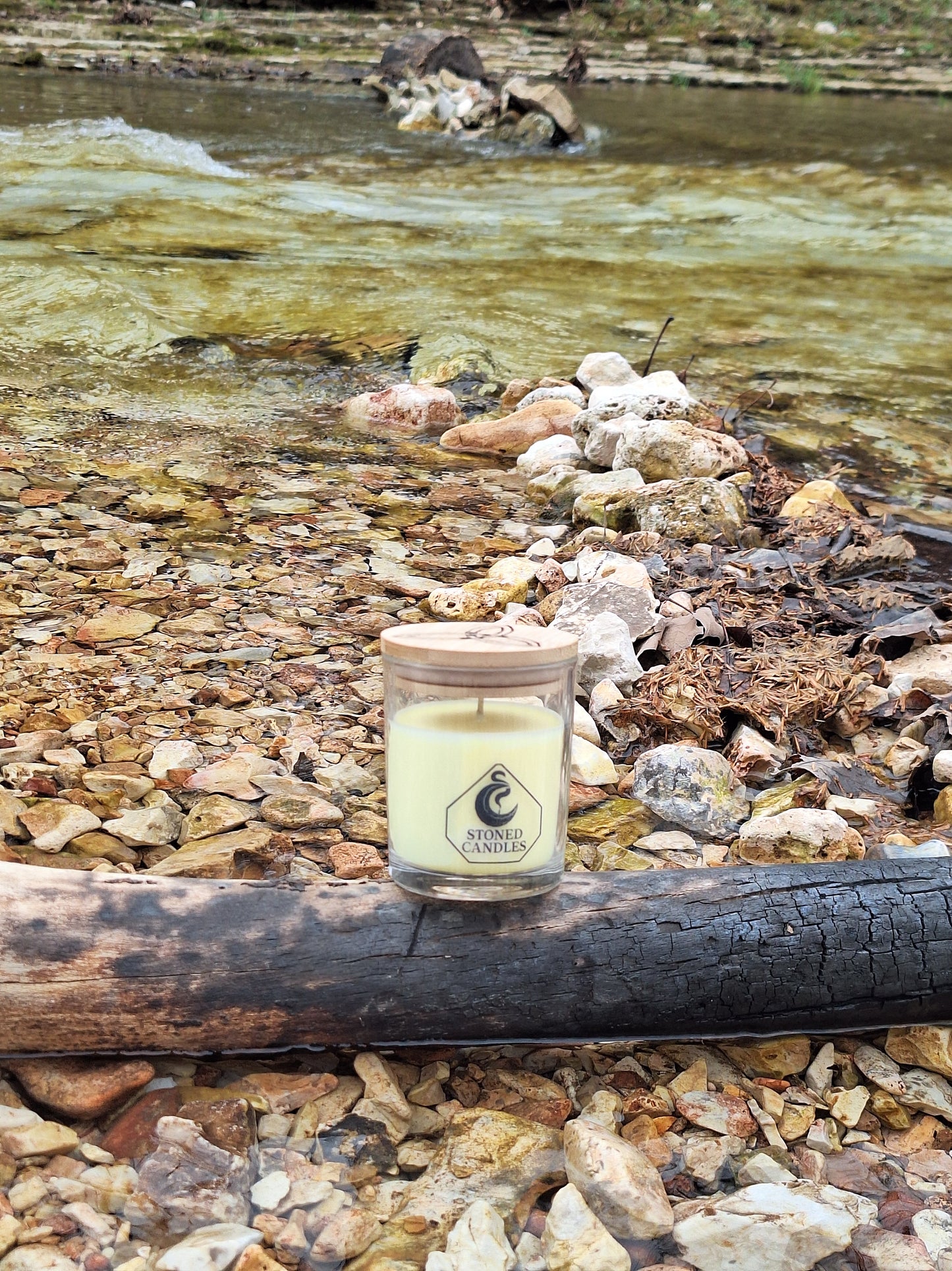 Small cylindrical container with a logo on a textured surface